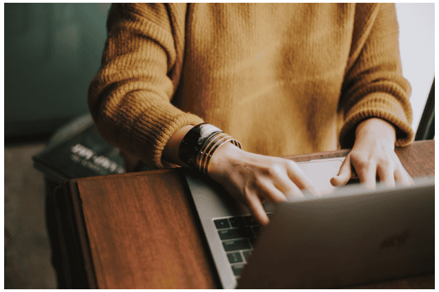 A person working in a desk with a laptop